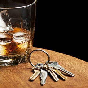 A Wine glass with keys symbolizing DWI